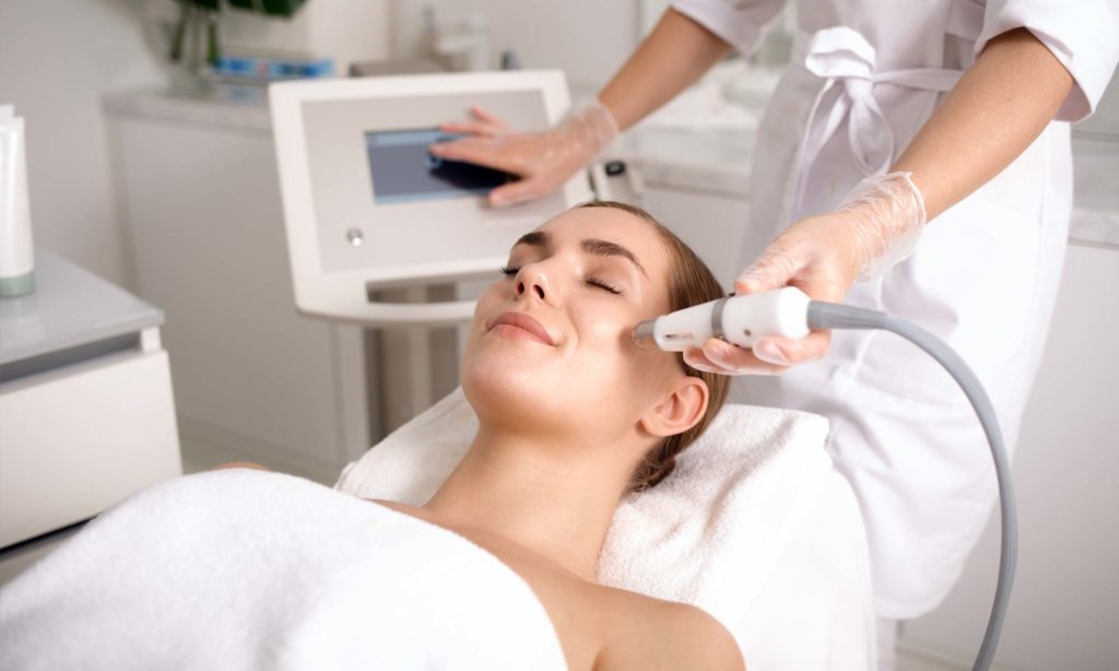 Female patient receiving IPL lumecca treatment on face
