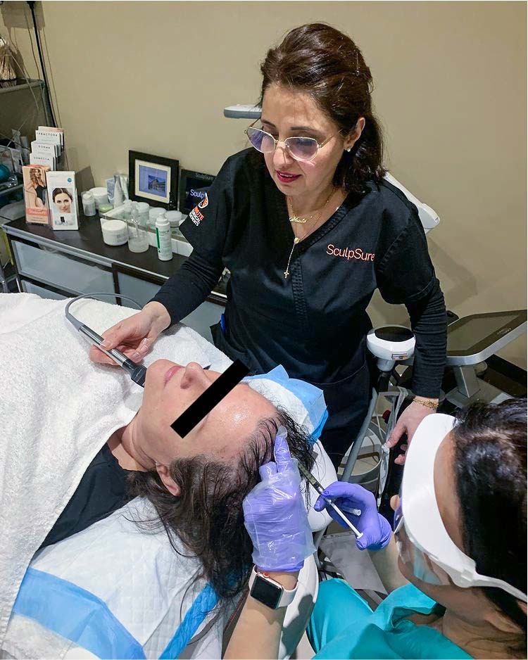 Doctor performing PRP prp platelet rich plasma vampire facelift treatment on female patient