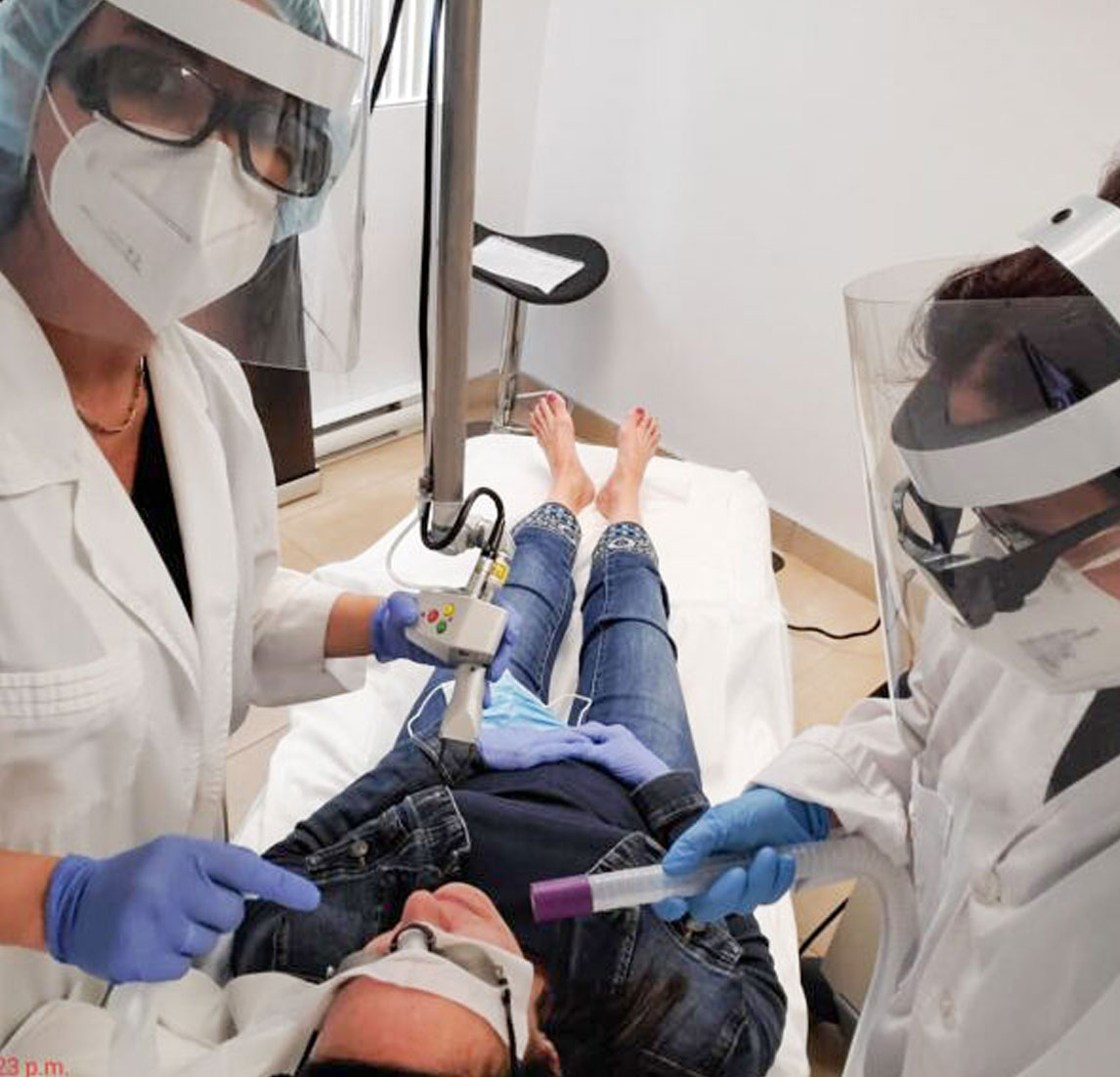 Technicians performing smartskin laser treatment on patient