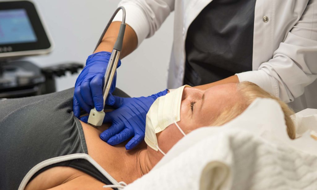 Female patient receiving chemical peel treatment